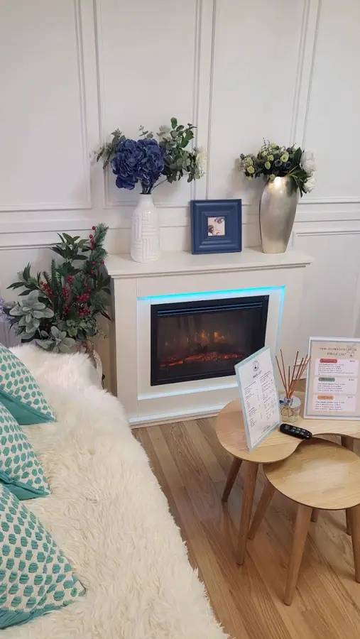 The lounge with a fireplace and mint cushions