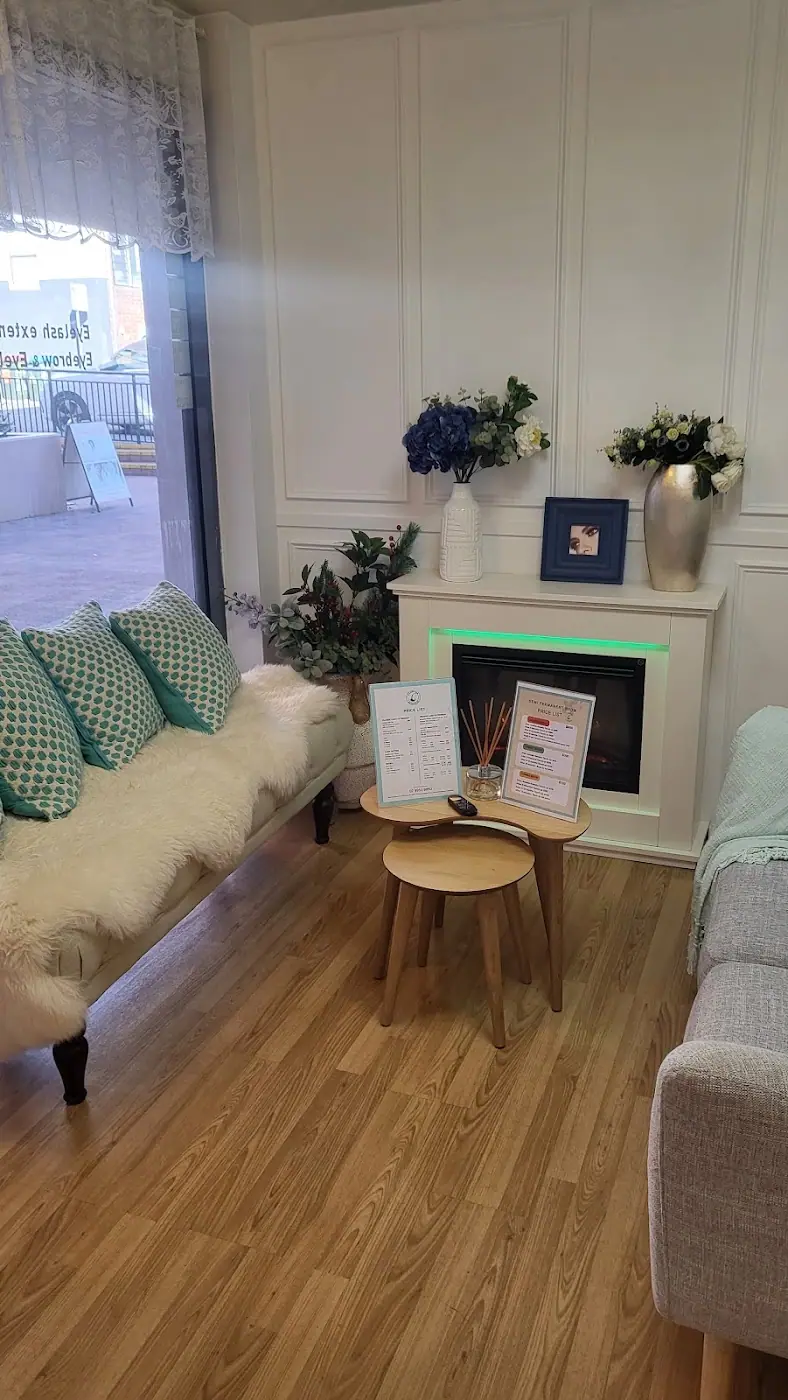 The lounge at C Lash Bar, with mint cushions and a fireplace